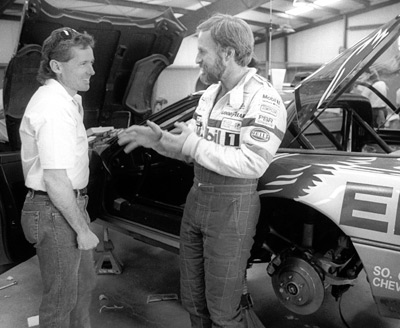 A few days before the Run, Stu Hayner (left) and John Heinricy discuss the car's handing in the garage at Ft. Stockton. Image: Author.